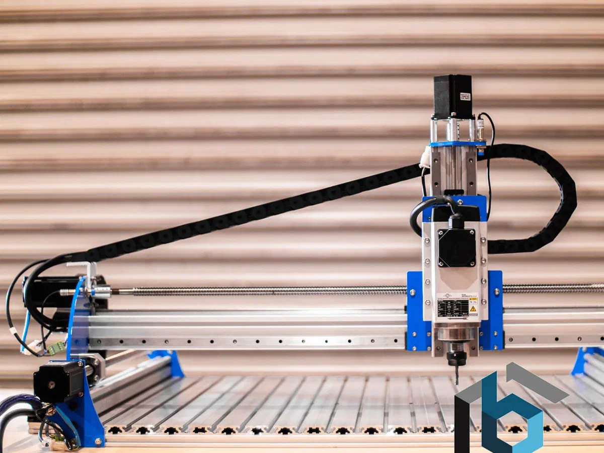 A BlueCarve Turbo CNC router with a blue gantry on a slatted bed.