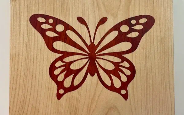 A V-carve inlay with a contrasting wood plug seated in a pocket